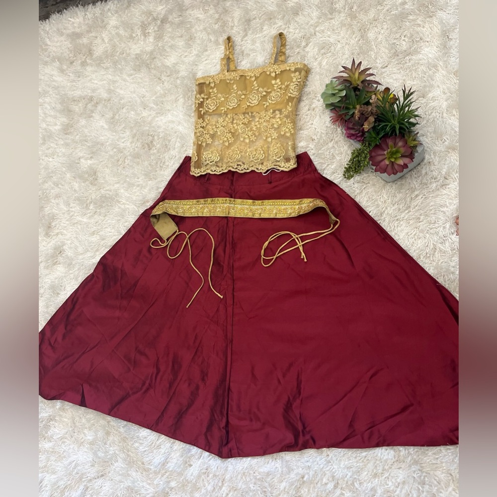 Brown Patiala pant with golden top and belt.